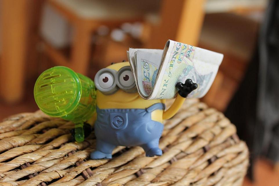 A picture of a minion with money