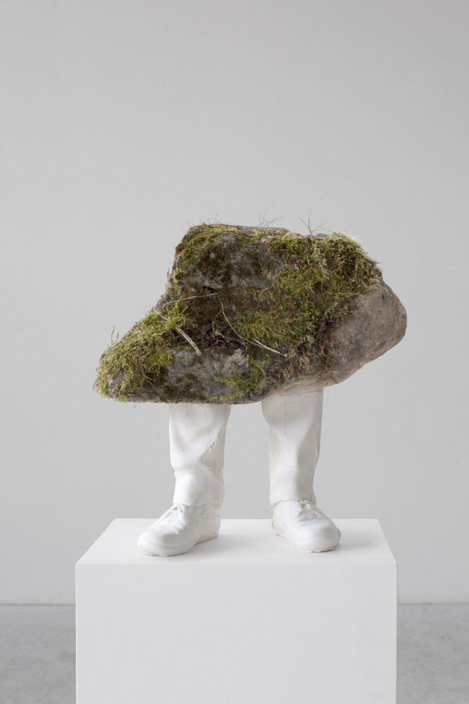 sculpture of a stone with legs
