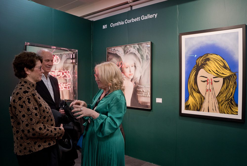 Gallerist Cunthia Corbett (left) talking to clients at her gallery booth