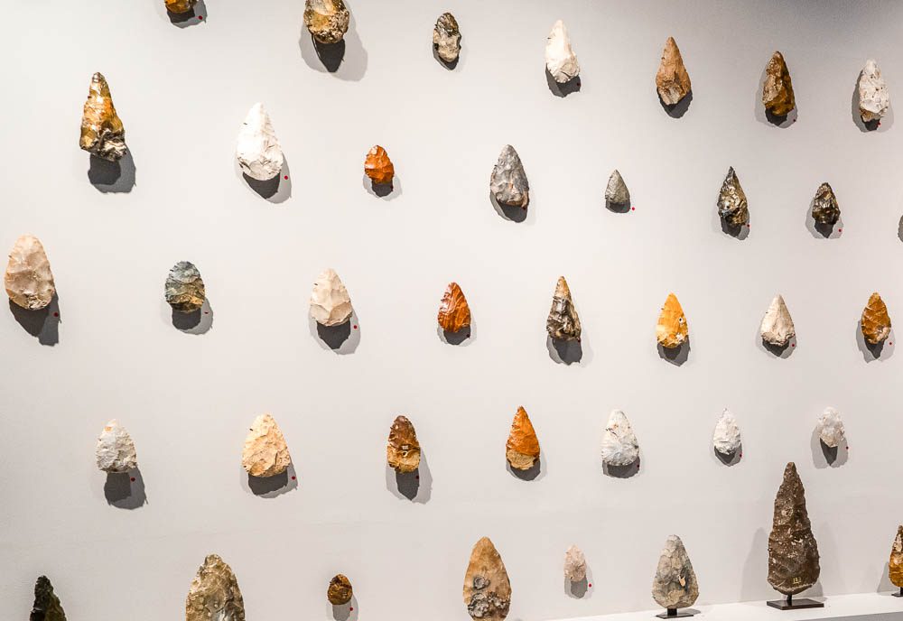 Visitors,collectors view stone age implements at Art Ancient gallery at Frieze Masters  2023  International Arts Fair in Regent's Park, London,UK