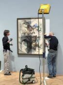 Curators installing an artwork featured in the exhibition In the Eye of the Storm, Vienna