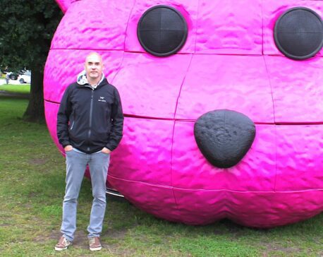 Photograph of Paul Robinson (LUAP) with his Pink Bear sculpture in Hamburg