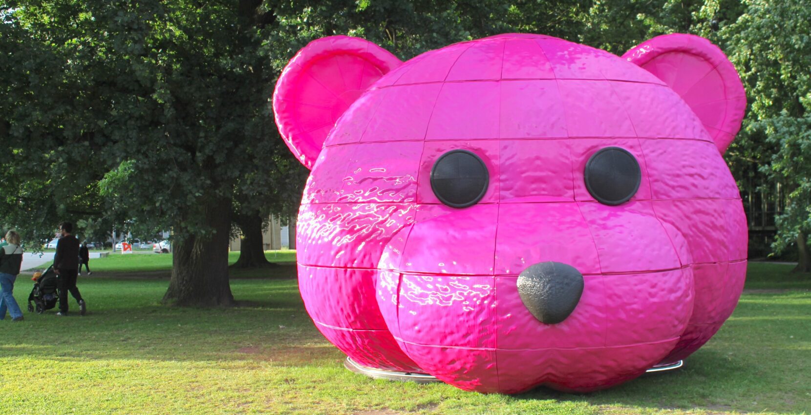 A photograph of a pink bear head sculpture by LUAP