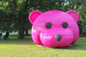 A photograph of a pink bear head sculpture by LUAP