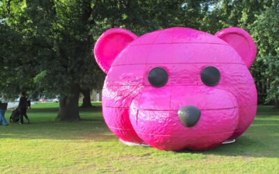 A photograph of a pink bear head sculpture by LUAP