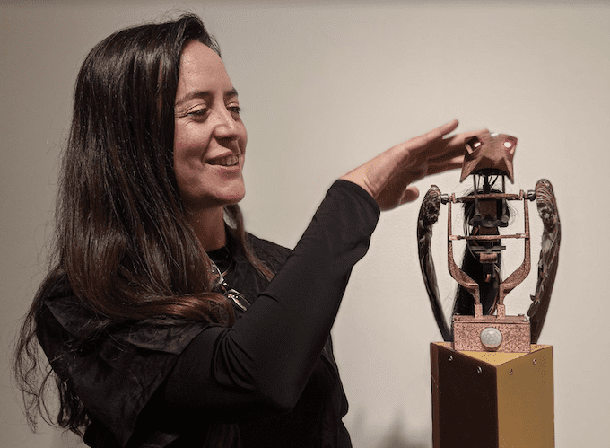 Image shows a Portrait of Patricia Dominguez and 'Rocky 1' robotic sculpture, by Julio Etchart