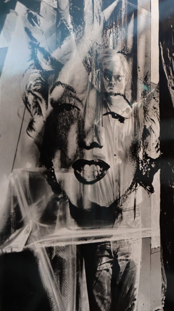 A photo by Julio Etchart showing a William John Kennedy image of Andy Warhol and Marilyn Monroe